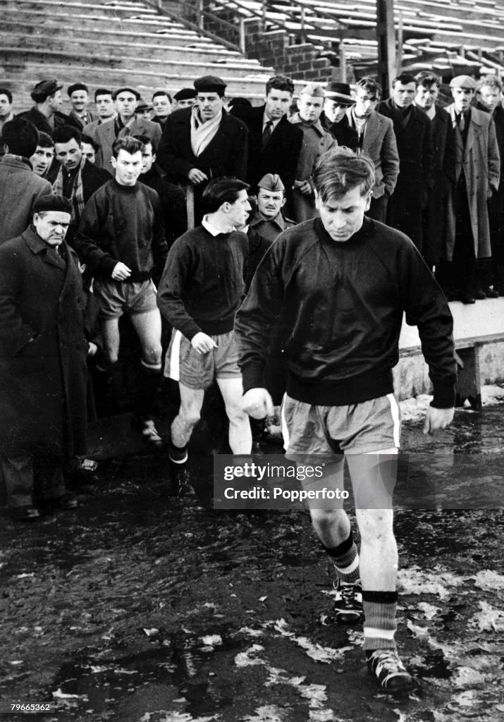 Football, Belgrade, Yugoslavia, 4th February, 1958, Manchester United players led by Bobby Charlton run onto the pitch in the Yugoslav Army Stadium in Belgrade to train for their European Cup match v Red Star Belgrade to be played on 5th February