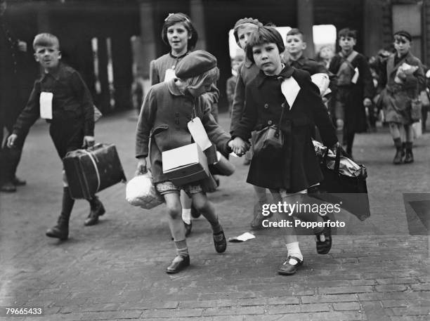 World War II, 11th June 1944, London, England, Little girls carry their belongings to their train at Euston station en route to their evacuation to...
