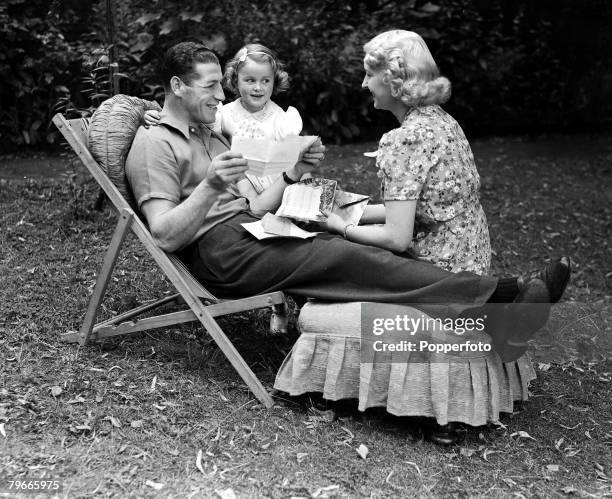 Boxing, 11th July 1939, Len Harvey the new light-heavyweight champion of the world, relaxes in the garden of his Kensington, London, home with his...