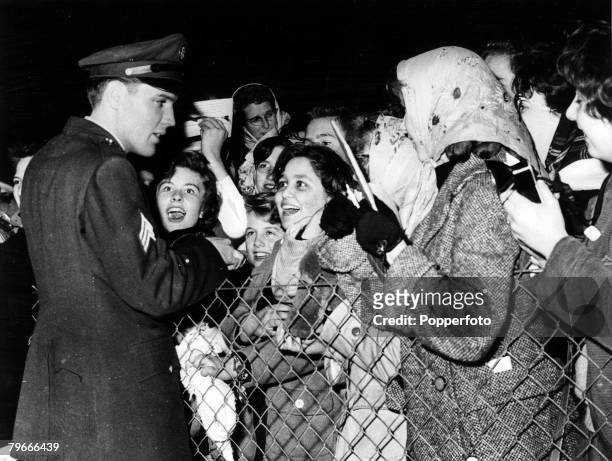 4th March 1960, Prestwick, Scotland, Sergeant in the US army Elvis Presley, American rock and roll singer, meets screaming fans at Prestwick Airport...
