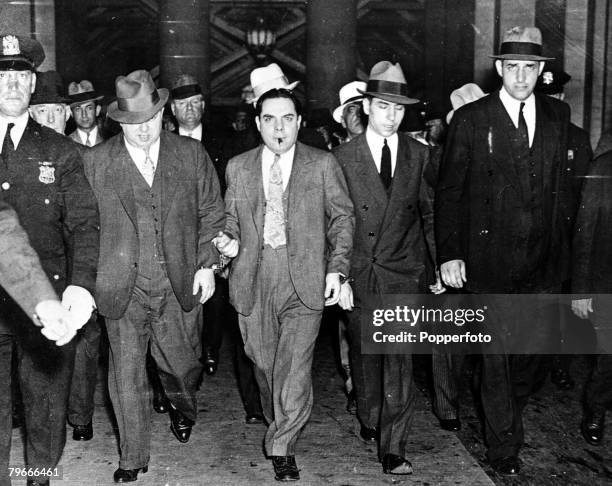 New York, USA, June 1936, American Gangster Charles +Lucky+ Luciano being led from a New York court by a posse of detectives to start a sentence of...