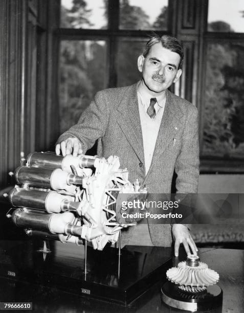 May 1948, Air Commodore Frank Whittle aged 40, pictured next to a model of a prototype jet engine which he invented at Brownsover Hall, Rugby,...
