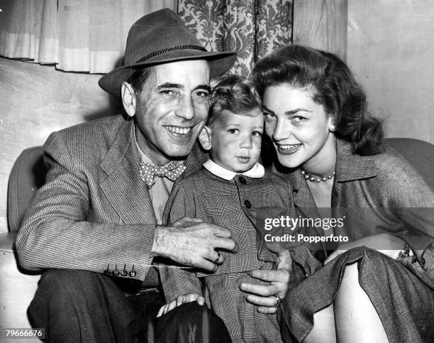 Southampton, England, 8th September American film actor Humphrey Bogart and his wife Lauren Bacall smiling with their young son Stephen as they leave...