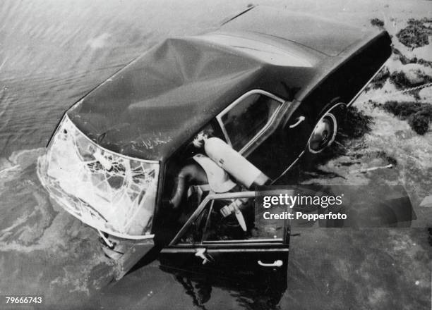 Edgartown, Massachusetts, USA, 19th July Frogmen dive into the water as they try to raise the car belonging to Senator Edward Kennedy in which he was...