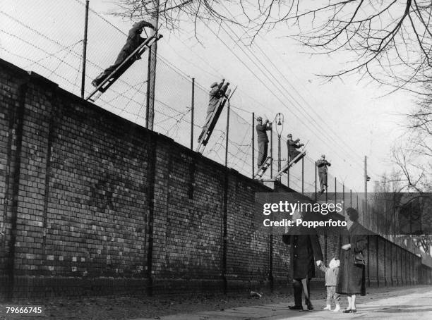 Berlin, Germany, 19th November East Berlin border guards adding barbed wire to the newly built Berlin Wall, The wall was set up the Soviet army to...