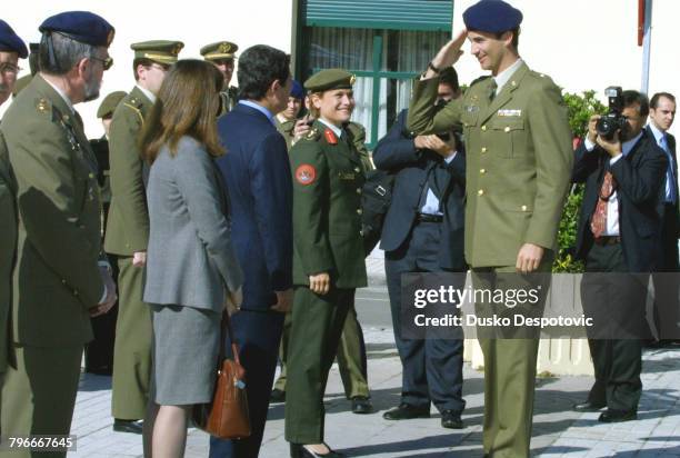 Prince Felipe salutes the Spanish Royal Guard in the presence of Princess Aisha of Jordan.