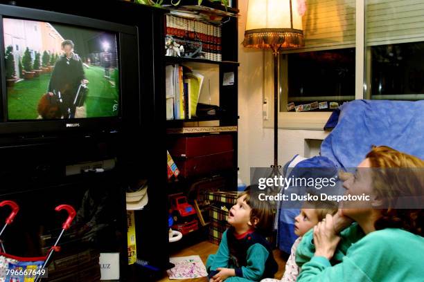 Family watching the TV program 'Gran Hermano', the Spanish version of 'Big Brother'.