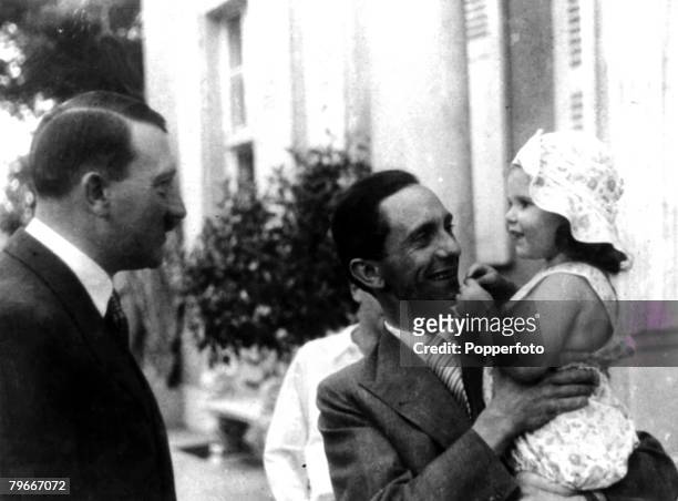 21st November 1934, German Chancellor and Nazi dictator Adolf Hitler, left, chats to his Propaganda Minister Dr, Goebbels who is holding his daughter...