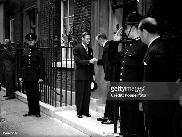 World War II, London, England, 1st September 1939, King George VI is pictured shaking hands with British Prime Minister Mr, Neville Chamberlain as he...