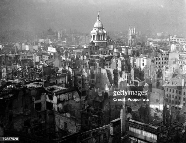 Circa 1940, Part of the City of London near the undamaged St Paul's cathedral in the background showing some of buildings burning as a result of...