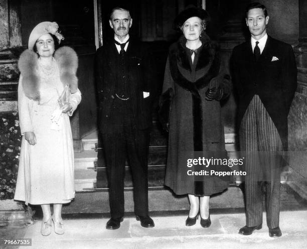 5th November 1938, British Prime Minister Neville Chamberlain and his wife can be seen on the balcony at the Palace with King George VI and Queen...