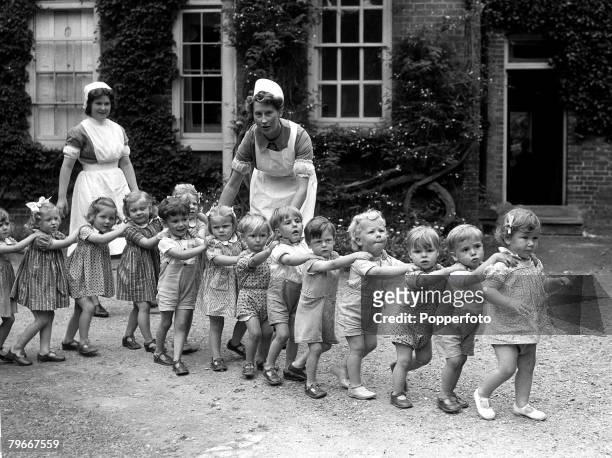 September 1942, Children playing trains with nurses in the grounds of Eichelford House in Hertfordshire, the home of Mrs Randolph Churchill, used as...