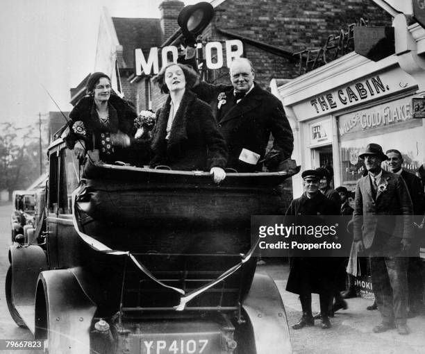 Essex, England, circa 1930's, British politician Winston Churchill waves his hat to salute constituents as he tours the Epping constituency in an...
