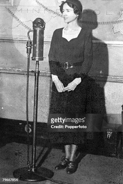 5th March Mrs, Charles Lindbergh, wife of the famous American aviator, stands before a microphone at the time when there was an intensive search for...