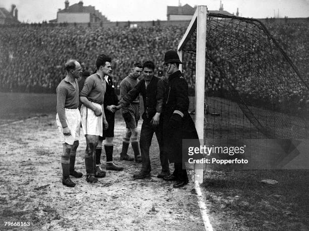 Football, London, England, 25th January 1931, FA Cup, A fan in the Everton goalmouth with goalkeeper Coggins and dismayed police and players...
