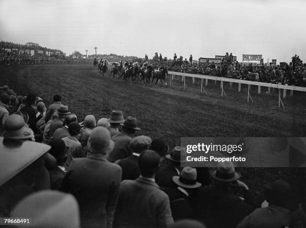 Surrey, England, 4th June The field of horses making their way around the bend at Tattenham Corner during the Epsom Derby which was won by the Aga...