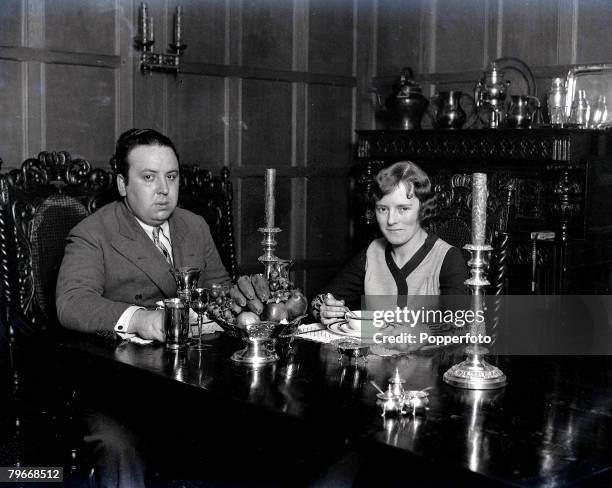 Mr, Alfred Hitchcock, the British film genius, photographed in his beautiful London home, with his wife, Miss Alma Tremayne