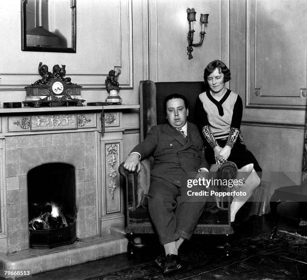 Mr, Alfred Hitchcock, the British film genius, photographed in his beautiful London home, with his wife, Miss Alma Tremayne