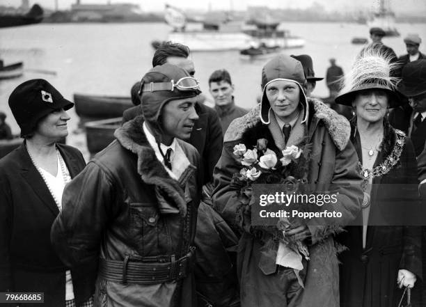 American aviator Amelia Earhart holds a bouquet of flowers upon her arrival at Southampton after piloting her aeroplane ,Friendship from Burry Port,...