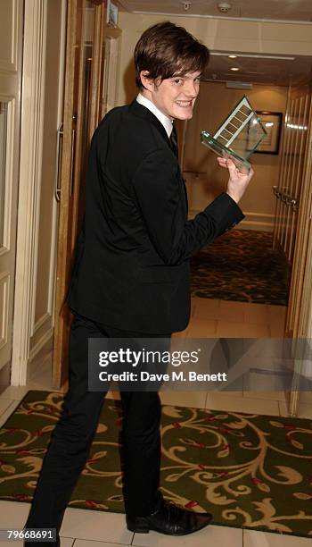 Sam Riley poses in the awards room with the Breakthrough Award in Acting during the Awards Of The London Film Critics Circle, at the Grosvenor House...