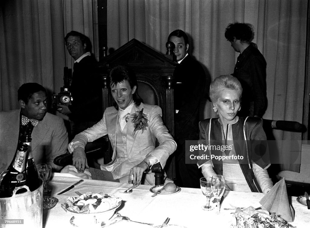 Singer, Pop star David Bowie (centre) and his wife Angie at a party given by Bowie at the Cafe Royal following his last public concert at the Odeon Theatre, Hammersmith, Bowie announced that he plans to start a new career in films