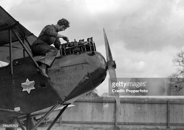 Aviation, London, 30th March English pilot Miss Amy Johnson pictured resting from working on the engine of her De Havilland "Moth" aeroplane at Stag...