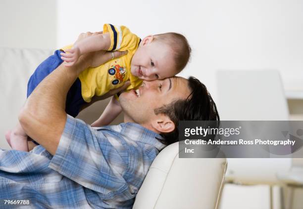 asian father hugging baby - baby father hug side stock pictures, royalty-free photos & images