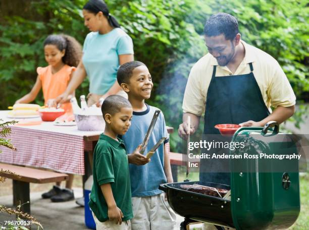 multi-ethnic family barbecuing in park - bbq family park imagens e fotografias de stock