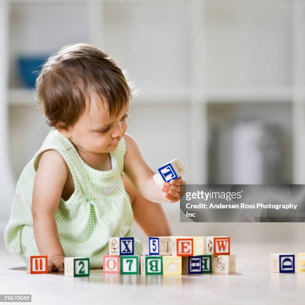 hispanic baby playing with blocks - abc blocks stock pictures, royalty-free photos & images