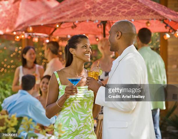 african american couple talking at party - white and black women and umbrella stockfoto's en -beelden