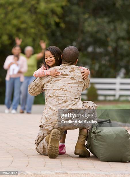 african american military father hugging daughter - marines stock pictures, royalty-free photos & images