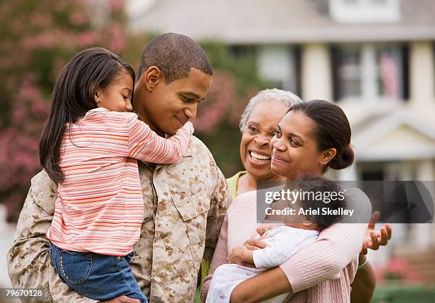 african american military father hugging family - marineinfanterie stock-fotos und bilder