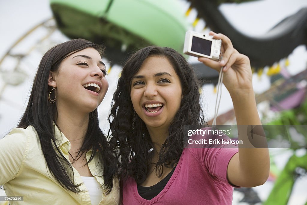 Multi-ethnic teenaged girls taking own photograph