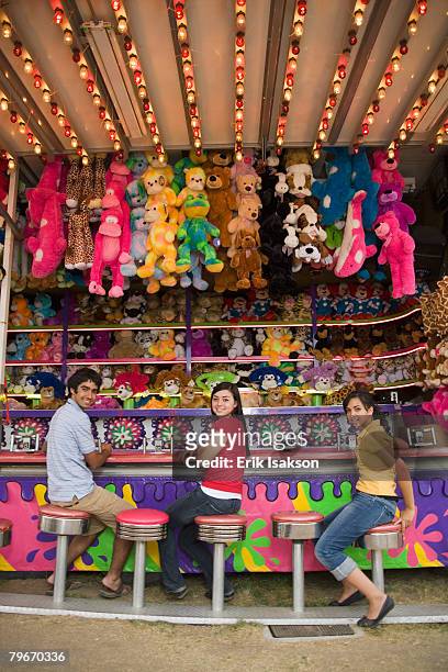 multi-ethnic teenaged friends at carnival booth - awards day 3 stock pictures, royalty-free photos & images