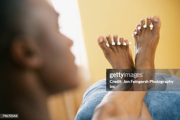 african man getting pedicure - fußpflege stock-fotos und bilder