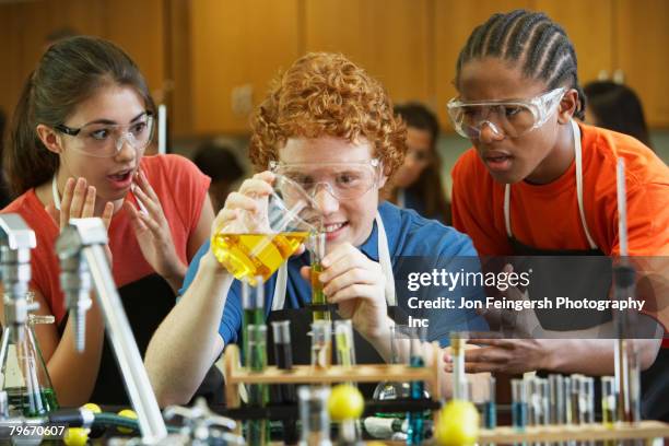 multi-ethnic teenaged students in science class - girl liquid foto e immagini stock