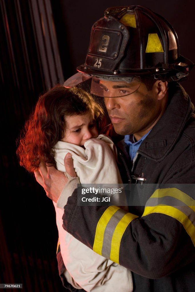 Hispanic male firefighter holding child