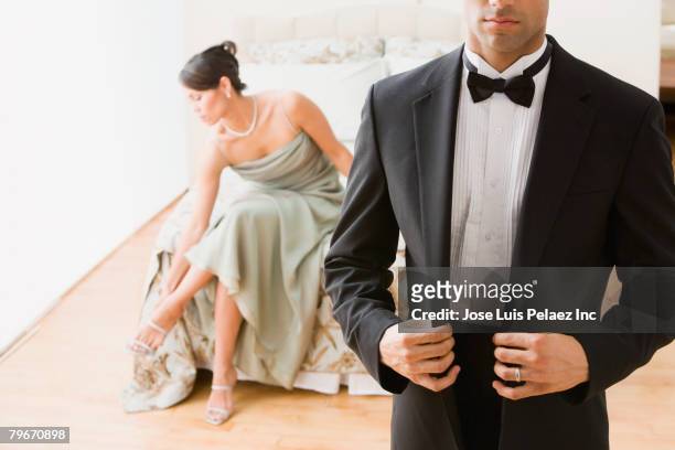 hispanic couple in evening wear - tuxedo stock-fotos und bilder