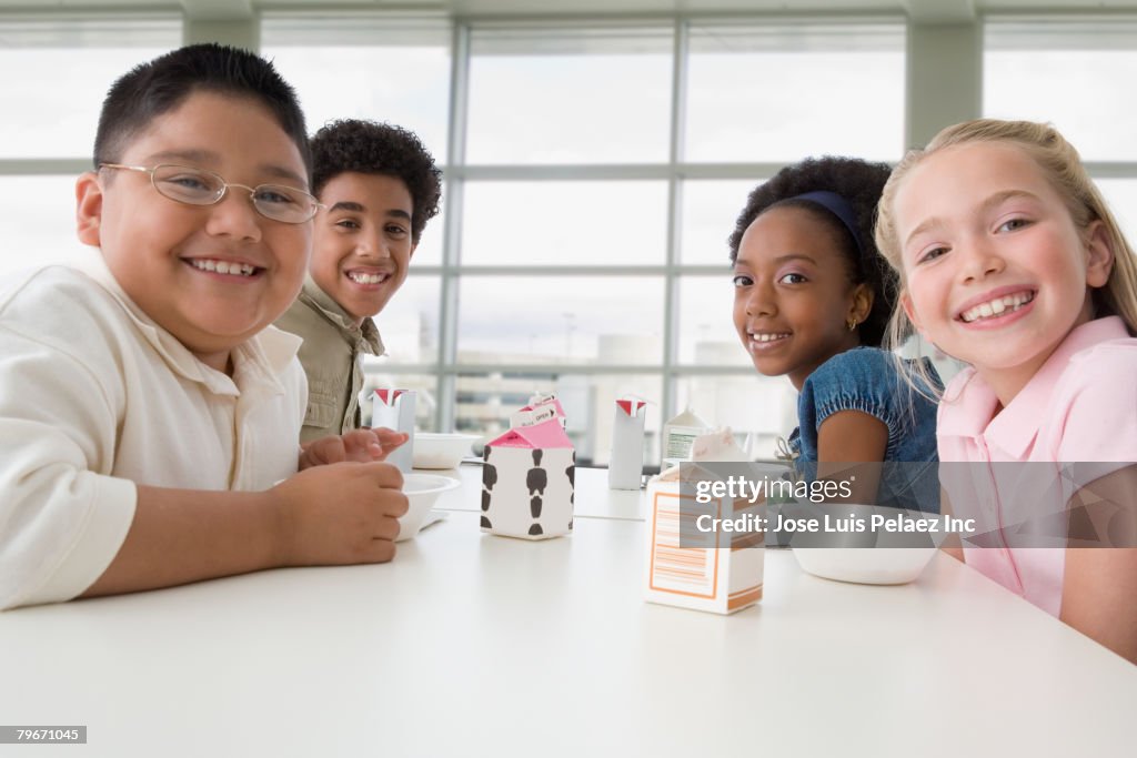 Multi-ethnic children eating in cafeteria