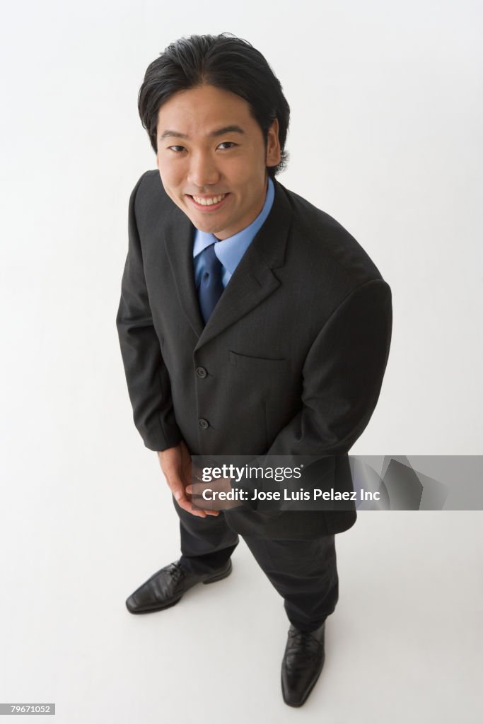 Asian businessman with hands clasped