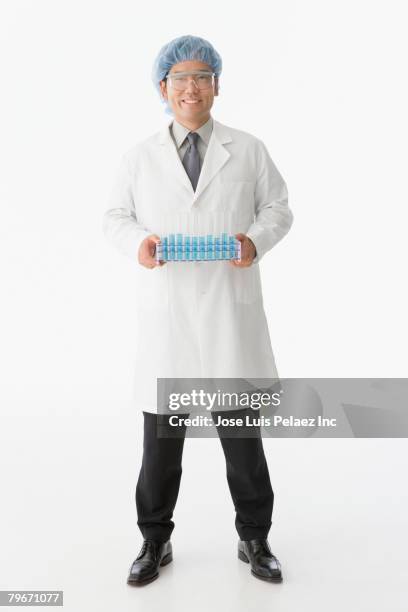 asian male scientist holding tray of vials - reagenzglas freisteller stock-fotos und bilder
