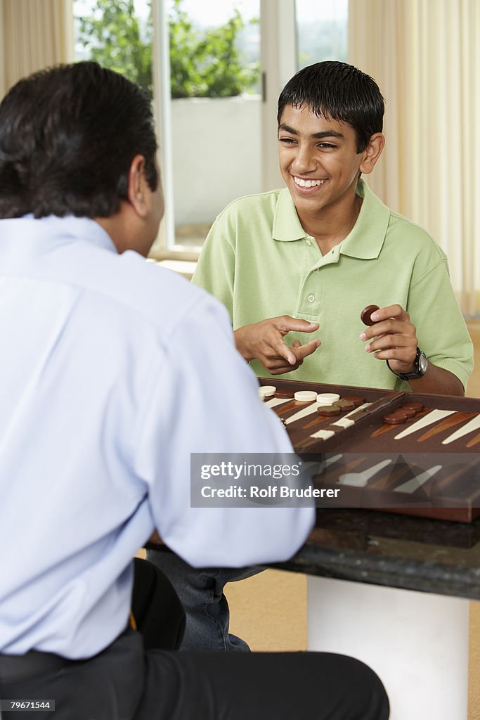 Middle Eastern father and son playing game