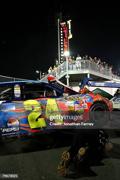 Jeff Gordon, driver of the DuPont Chevrolet, gets his car towed to the garage after being hit during practice for the Budweiser Shootout at Daytona...