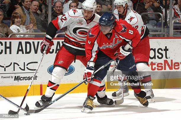 Alex Ovechkin of the Washington Capitals fights for loose puck during a hockey game against Eric Staal of the Carolina Hurricanes on February 8, 2008...