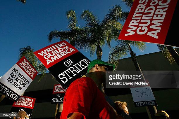 Writers Guild of America members and supporters picket in front of NBC studios as hope grows that a draft copy of a proposed deal with Hollywood...