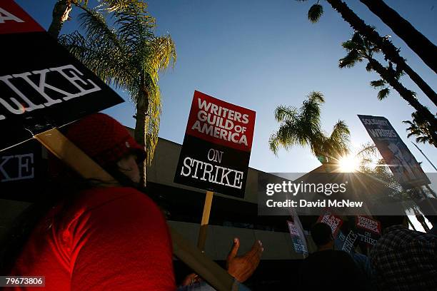 Writers Guild of America members and supporters picket in front of NBC studios as hope grows that a draft copy of a proposed deal with Hollywood...