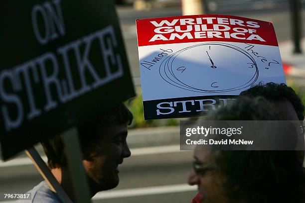 Picket sign addresses the question of whether the strike may end soon while Writers Guild of America members and supporters picket in front of NBC...