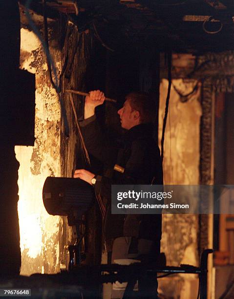 Member of the Austrian firebrigade scrutinizes the burnt walls of the Vinzenheim, home for the elderly, after a night time fire catastrophy on...