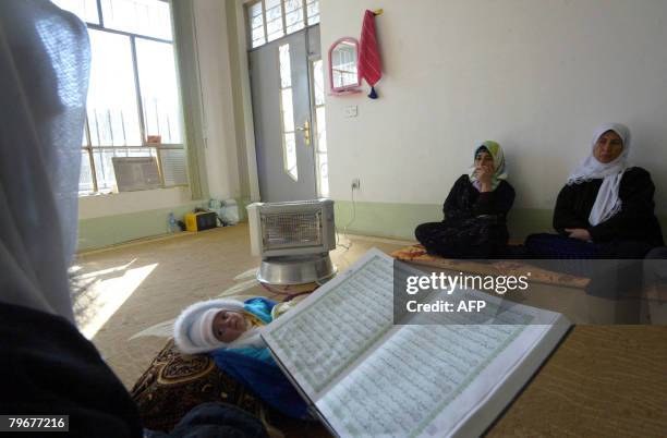 Sheikh Abdul Wahab performs rituals aimed to expel evil spirits from the body of a baby in the northern city of Arbil on February 3, 2008. A large...