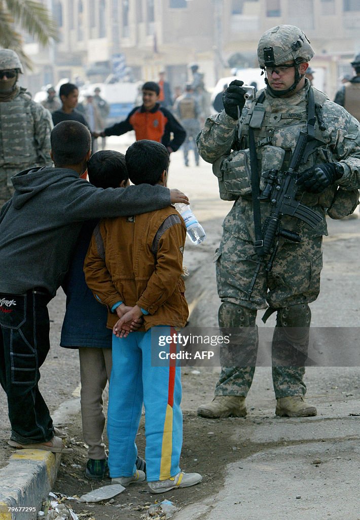 A US soldier takes a picture of Iraqi ch